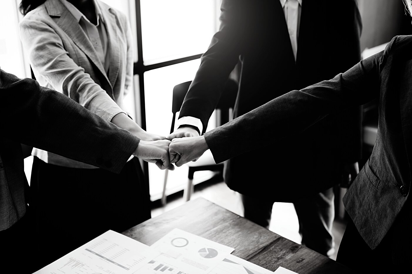 Group of business people showing merger symbol, together concept